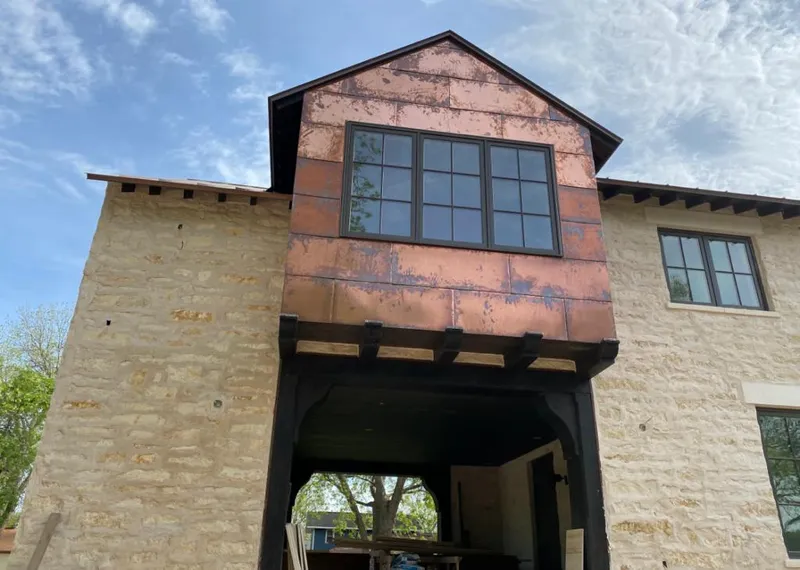 Copper metal panel facade on a stone building for Metal Roof Coating in Williston